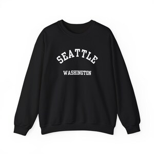 Seattle, Washington (Unisex Heavy Blend Crewneck Sweatshirt) Pacific Northwest, PNW Souvenir, Rainy City, USA Travel Gift - White font