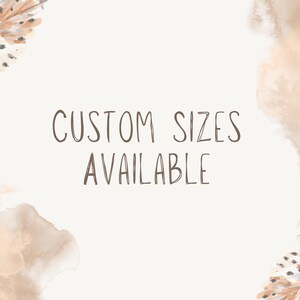 May include: A cream-colored background with watercolor-style feather and cloud accents. The text "CUSTOM SIZES AVAILABLE" is written in a brown, handwritten-style font, suggesting a customizable product or service.