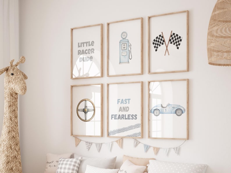 May include: A set of six framed art prints with a racing theme. The prints feature illustrations of a gas pump, checkered flags, a steering wheel, a vintage race car, and text that reads "Little Racer Dude" and "Fast and Fearless".