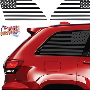 May include: A red SUV with a black and white American flag decal on the rear window. The decal is a silhouette of the American flag.