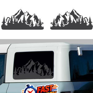 May include: Two dark grey mountain and forest decals. One is applied to a vehicle window, and two are separate. A sticker on the vehicle reads "FAST DELIVERY" with a clock graphic and "Free Shipping".