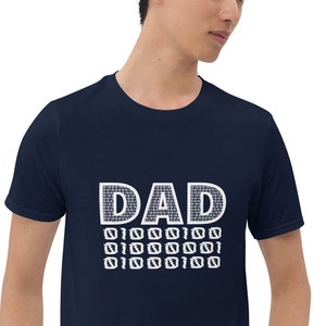May include: A navy blue t-shirt with a white graphic that says "DAD" with a pattern of small squares.