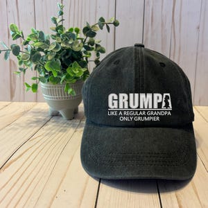 May include: Black baseball cap with white embroidered text that reads "Grump Like a Regular Grandpa Only Grumpier".