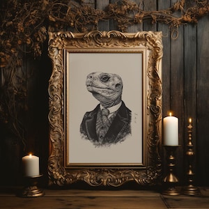 May include: A black and white illustration of a turtle wearing a suit and tie, framed in a gold ornate frame. The image is set against a dark wood background with two lit candles on either side.