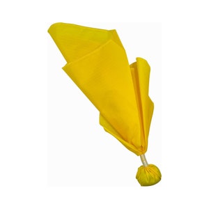 May include: A bright yellow fabric pouch with a drawstring closure. The pouch is folded and tied at the top, creating a rounded shape. The pouch is made of a soft, lightweight fabric.