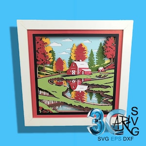May include: A framed 3D paper art piece depicting a rural autumn scene. The artwork features a red barn, trees with red and yellow foliage, and a reflective pond. The frame is white with a red border. The image includes the text "3D SVG" and "SVG EPS DXF".