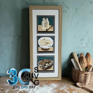 May include: A vertical framed wall art piece featuring three square illustrations depicting the sourdough bread making process: a jar of starter, a bowl of dough, and a finished loaf of bread in a basket, all set against a light wood frame.