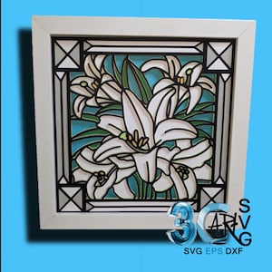 May include: A white framed artwork featuring a floral design of white lilies with green leaves against a light blue background. The artwork has a black border and the frame is white. The bottom right corner has the text "SVG EPS DXF".