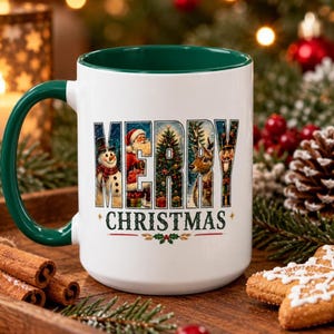 May include: A white ceramic mug with a dark green handle and interior. The front features the text MERRY CHRISTMAS in large block letters, with each letter filled with festive imagery including a snowman, Santa Claus, a tree, and a reindeer.