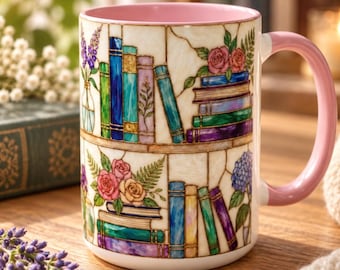 May include: A ceramic mug with a pink interior and handle, featuring a wrap-around stained glass style illustration of two shelves filled with colourful books, vases of flowers, and floral arrangements including roses and hydrangeas.