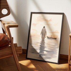 May include: A framed watercolor painting depicting a man walking on water towards a small boat. The painting has a soft, muted color palette with shades of blue, brown, and white. The background features a hazy sunset sky.