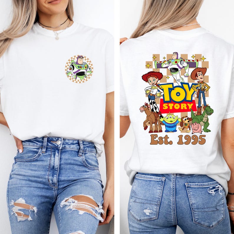 May include: White t-shirt featuring a Buzz Lightyear graphic on the front and a Toy Story design on the back. The back design includes characters like Woody, Jessie, and the text "TOY STORY Est. 1995".
