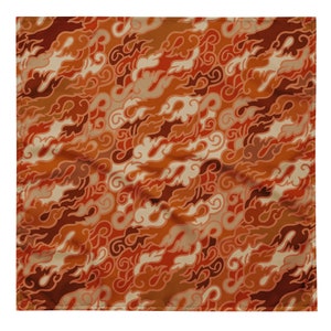 May include: A square fabric with a repeating pattern of orange, brown, and cream coloured flames. The fabric has a slightly wrinkled texture.