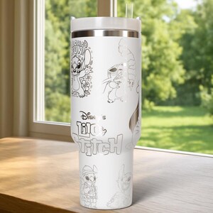 May include: White insulated tumbler featuring line art illustrations of Stitch from Lilo & Stitch. The tumbler includes the text "Aloha Fun!" and "Disney's Lilo & Stitch". It has a white lid and a clear straw. The tumbler is on a wooden surface.
