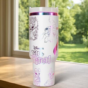 May include: White tumbler featuring multiple illustrations of Stitch from Disney's Lilo & Stitch, with the text "Aloha Fun" and "Disney's Lilo & Stitch". The tumbler has a white lid and a pink and purple iridescent band.