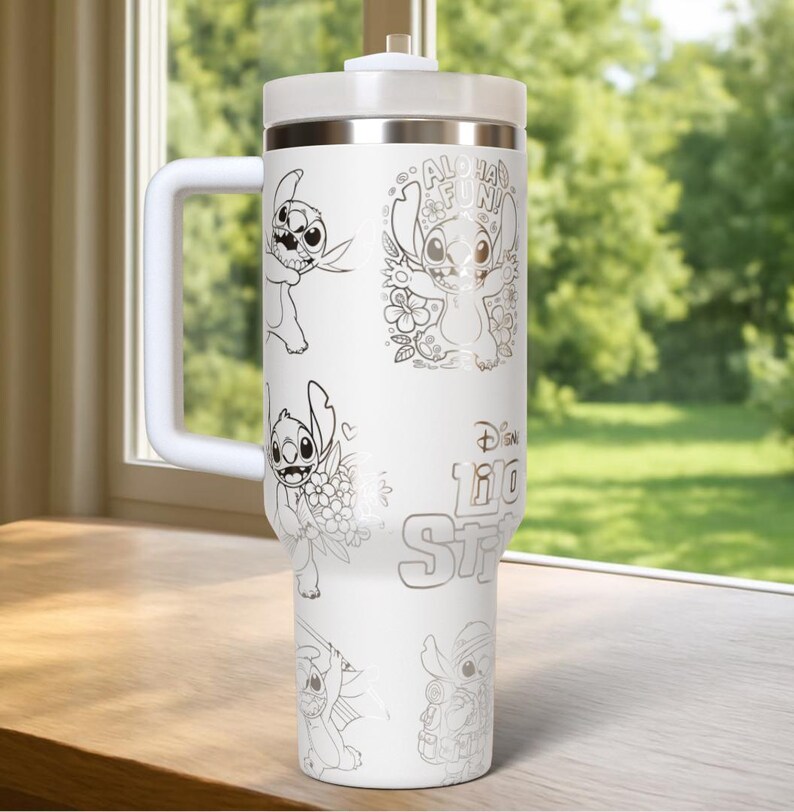 May include: White travel mug featuring illustrations of Stitch from Lilo & Stitch. The mug has a white handle, lid, and a silver rim. The text "Aloha Fun!" and "Disney Lilo & Stitch" are also visible on the mug.