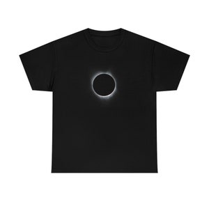 May include: A black t-shirt featuring a white image of a solar eclipse.