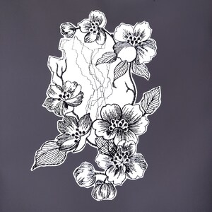 May include: Black and white line drawing of a floral arrangement with delicate flowers and leaves. The flowers are stylized and have a vintage feel.