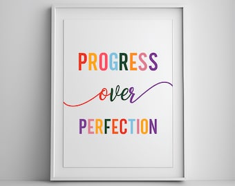 May include: A white framed print with the text "PROGRESS over PERFECTION" in colorful letters. The word "over" is written in a cursive font.