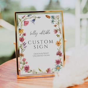 May include: A gold-framed sign with a floral border and the text "fully editable CUSTOM SIGN DESIGN & PRINT UNLIMITED SIGNS".