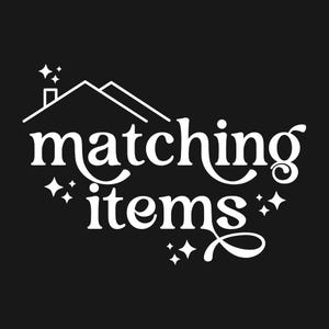 May include: White logo with a stylized house and the text "matching items" with stars around the text.