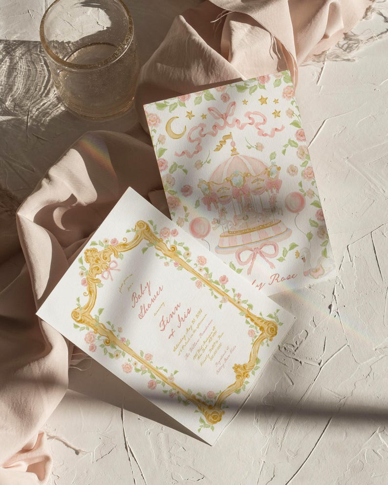 May include: A pink and gold baby shower invitation with a floral border and a carousel illustration. The invitation reads "Baby Shower honoring Finn & Iris".