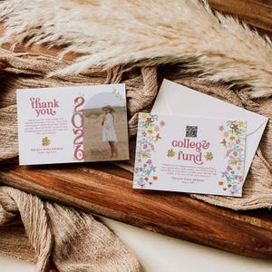 May include: Two graduation thank you cards and an envelope are displayed on a wooden surface. One card says "thank you" and "2026" with a photo of a person. The other card says "college fund" with floral accents.