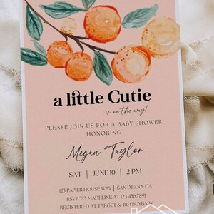 May include: A peach-colored baby shower invitation with a watercolor illustration of a branch with green leaves and orange fruit. The text reads "a little cutie is on the way!" and includes the name "Megan Taylor", the date "June 10", the time "2 PM", the address "123 Papier House Way, San Diego, CA", the RSVP information "RSVP to Madeline at 123.456.7891", and the registry information "Registered at Target & BuyBuyBaby".