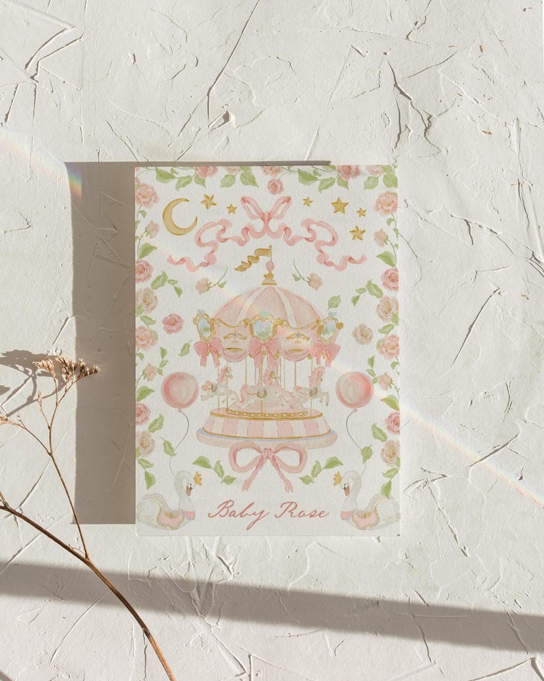 May include: A pink and gold carousel with white horses and pink ribbons. The carousel is surrounded by pink flowers and green leaves. The text "Baby Rose" is written below the carousel.