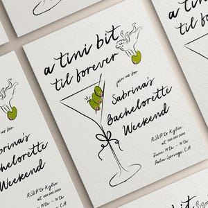 May include: A white invitation card with black calligraphy that reads "a tini bit til forever" and "join us for Sabrina's Bachelorette Weekend". The card features a black and white illustration of a martini glass with green olives and a small angel with a halo.