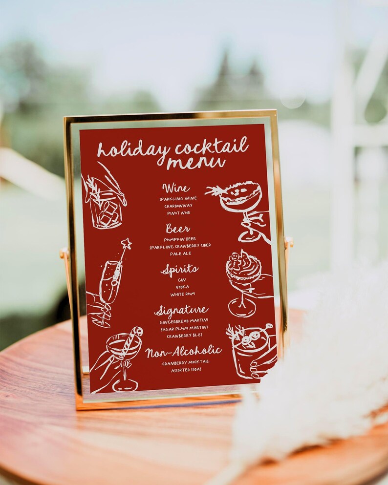 May include: A gold-framed sign with a red background lists a holiday cocktail menu. The menu includes options for wine, beer, spirits, signature cocktails, and non-alcoholic drinks. Each drink is illustrated with a hand-drawn image.