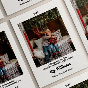 May include: A stack of holiday cards with a family photo inside a vintage truck bed. The cards have the year 2024 printed on them, along with the family name "The Williams" and a holiday greeting. The cards are on a white background.
