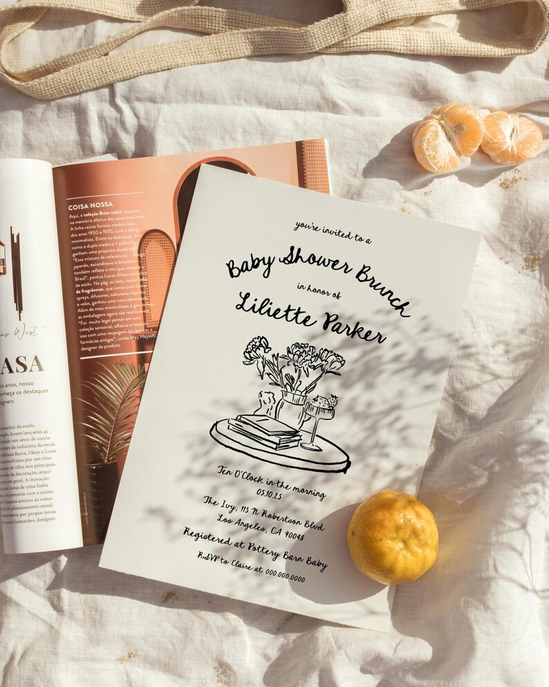 May include: A black and white illustration of a baby shower brunch invitation with a floral arrangement on a table. The invitation includes the text "Baby Shower Brunch", "in honor of", "Liliette Parker", "Ten O'Clock in the morning", "05.10.15", "The Ivy, 13 N Robertson Blvd", "Los Angeles, CA 90048", "Registered at Pottery Barn Baby", and "RSVP to Claire at 000.000.0000".