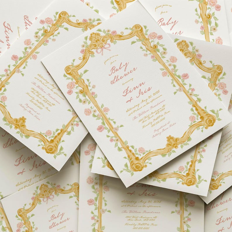 May include: A stack of baby shower invitations with a gold and floral design. The invitations are for a baby shower for Finn and Iris. The text on the invitations reads "Baby Shower for Finn and Iris, Saturday May 20, 2015, The Willow Residence, 457 West Henderson,  Kindly RSVP to (555) 555-5555.