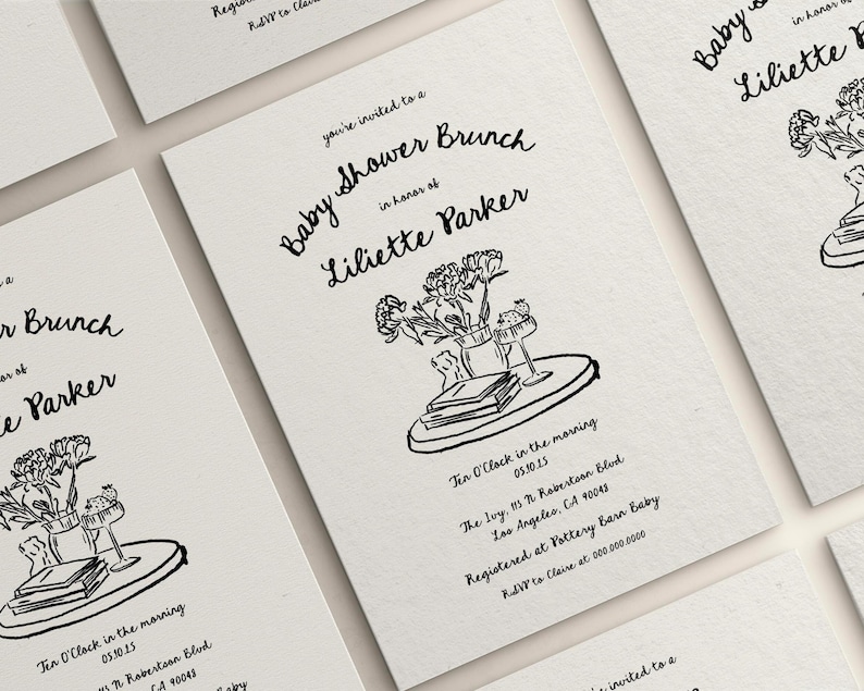 May include: A black and white illustration of a baby shower brunch invitation with the text "Baby Shower Brunch" and "Liliette Parker". The illustration includes a tray with a vase of flowers, books, and a glass.