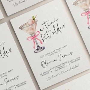 May include: White birthday party invitations with a watercolor illustration of a martini glass with a pink bow. The text reads "a tini bit older" and invites guests to celebrate Olivia James' birthday. Includes date, time, and location.