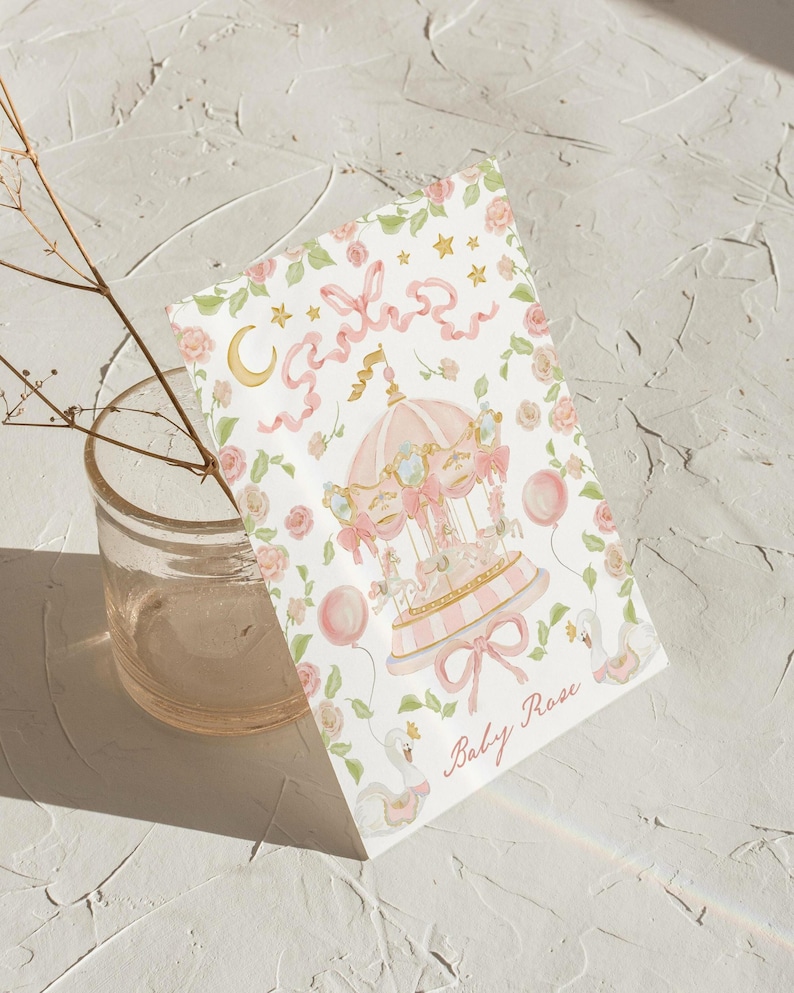 May include: A pink and white carousel with a gold star and ribbon design. The text "Baby Rose" is written below the carousel.
