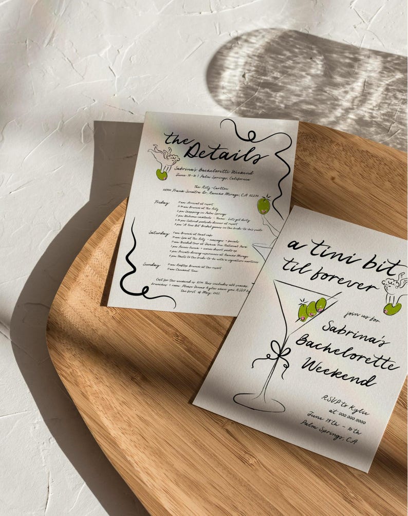 May include: A white card with black calligraphy text that reads "a tini bit til forever" and "join us for Sabrina's Bachelorette Weekend". The card also features a line drawing of a martini glass with olives. The text "RSVP to Kylie at 000-200-0000 June 17th - 20th Palm Springs, CA" is also included.