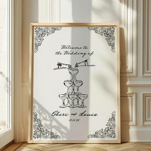 May include: A black and white wedding sign with a champagne tower illustration. The sign reads "Welcome to the Wedding of Cheri & Louis 12.14.25".