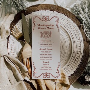 May include: A Thanksgiving dinner menu with a red border and a festive design. The menu lists the courses: First Course, Second Course, and Dessert. Each course includes a list of dishes, such as roasted butternut squash soup, maple walnut salad, honey glazed ham, and pumpkin pie.