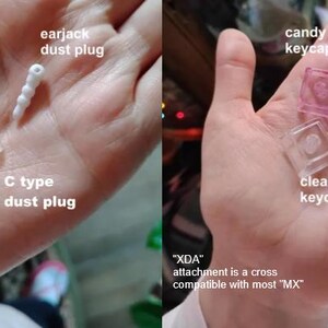 May include: A hand displays various small tech accessories. These include a white earjack dust plug, a clear C-type dust plug, and several keycaps in pink, clear, and lime green. The text indicates compatibility with most "MX" attachments.
