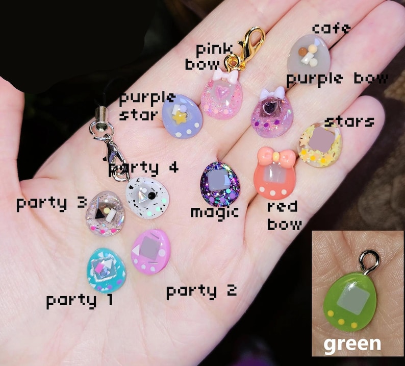May include: A selection of colourful resin charms featuring bows, stars, and geometric shapes. The charms are in pink, purple, green, and blue, with glitter details. Some charms have the text "party 1", "party 2", "party 3", "party 4", "magic", "cafe", "stars", "red bow", "purple bow", and "pink bow".