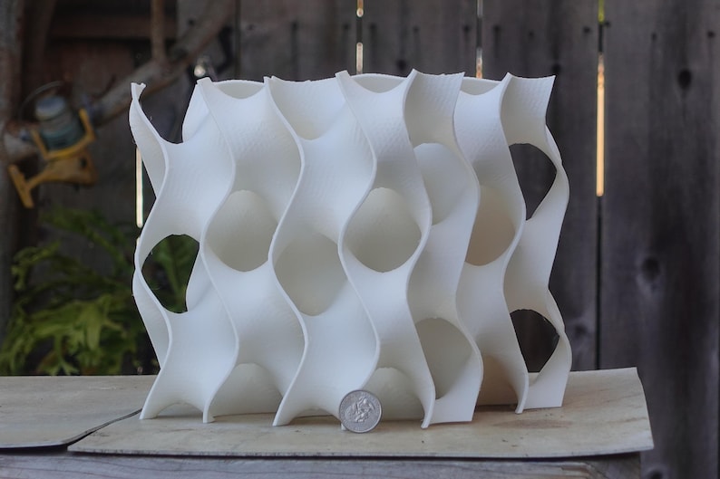 8x8 3D-printed gyroid aquarium cave with flowing patterns and openings. Ideal for fish and shrimp breeding, this white reef-safe sculpture adds a coral reef look. Perfect habitat for medaka, cichlids, and other aquatic pets.