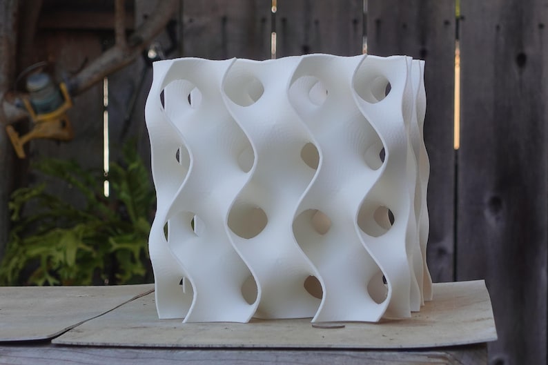Large 8x8 gyroid sculpture with a modern, wave-like design and openings. Perfect as a fish or shrimp breeding cave or tank décor, this reef-safe, white habitat adds a coral-inspired aesthetic to aquariums while providing shelter for aquatic pets.