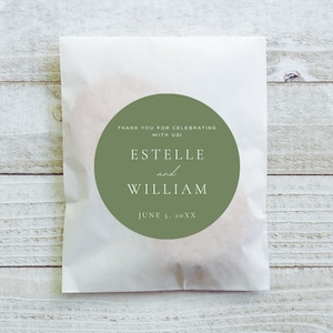 May include: A white paper bag with a green circle sticker that says "Thank you for celebrating with us! Estelle and William June 5, 20XX"