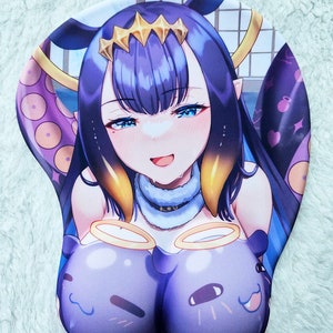 May include: A purple and blue mouse mat featuring a cartoon anime character with long purple hair and a crown. The character is wearing a white collar and has a light blue background. The mouse mat has two purple and blue cartoon characters on the bottom.
