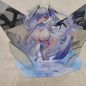 May include: A clear acrylic anime figure featuring a female character with long, flowing lavender hair and red eyes. The figure is supported by a light blue base and a clear, angular backdrop. The character is depicted in a dynamic pose.