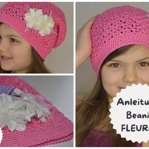May include: A pink crocheted beanie hat with a floral embellishment. The hat is adorned with white fabric flowers. The image also includes the text "Anleitung Beanie FLEURES".