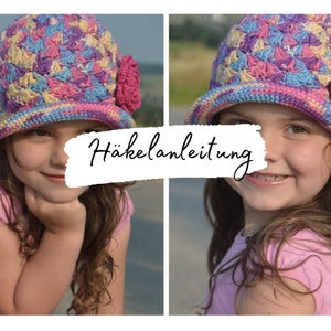 May include: A young girl wearing a colorful crocheted hat with a pink flower. The hat has a wide brim and is made with a variety of colors, including pink, purple, blue, and yellow. The girl is smiling and looking at the camera. The image includes the text "Häkelanleitung" which is German for crochet instructions.