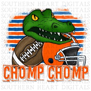 May include: A green alligator with a toothy grin, wearing a brown football and an orange football helmet. The background is a blue and orange striped pattern with the text "CHOMP CHOMP".